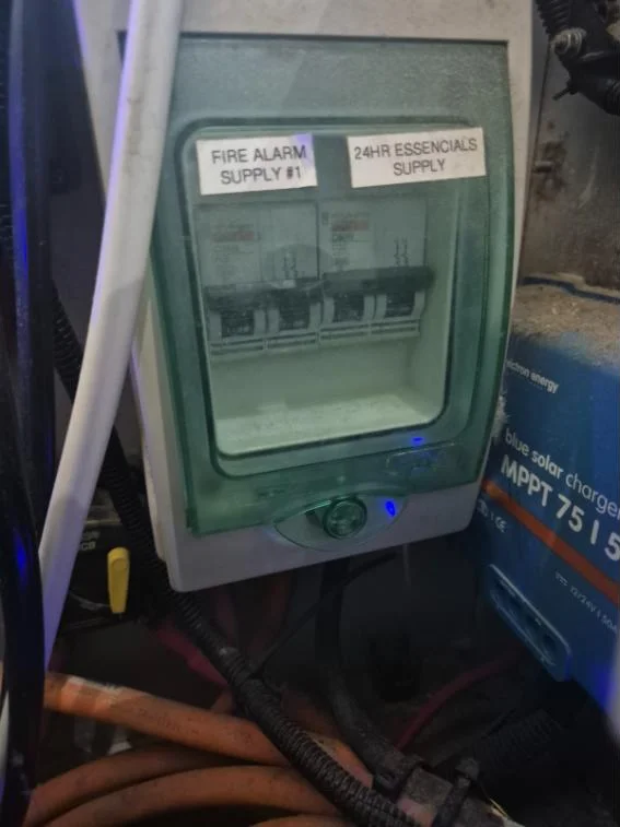 Labelled breaker enclosure for fire alarm and 24-hour essential supplies on a charter vessel