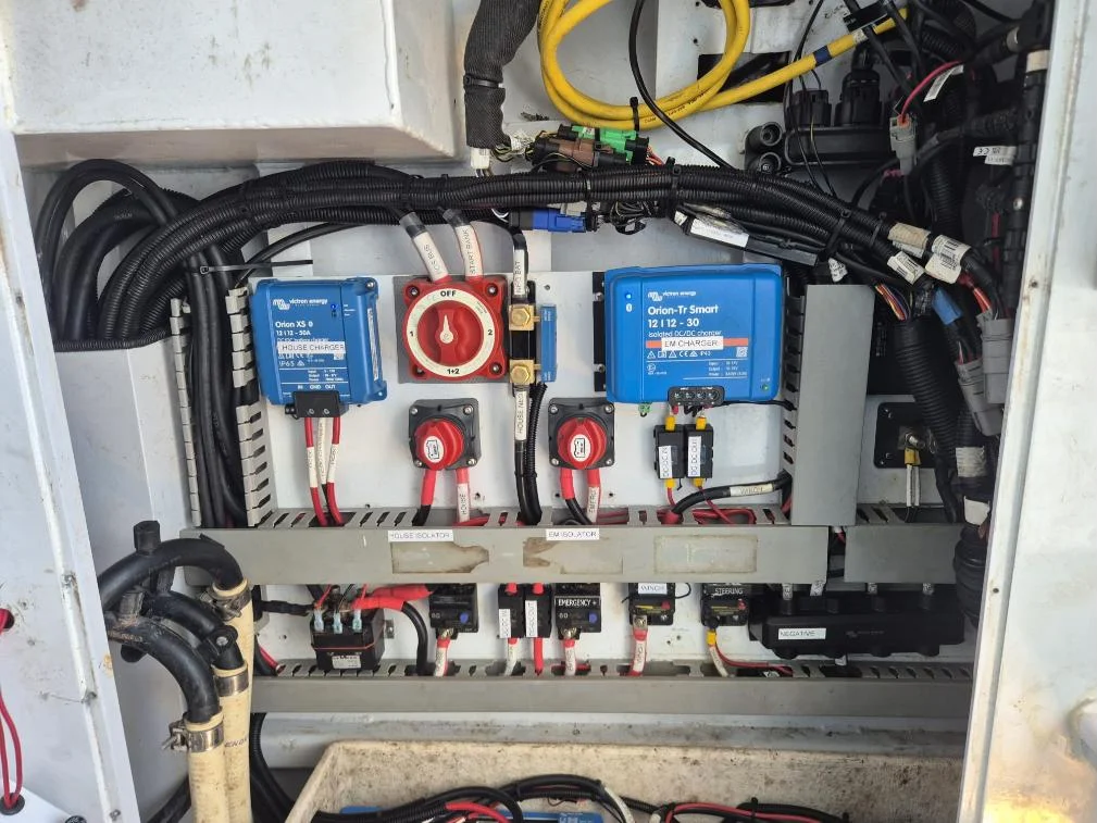 Labelled marine DC panel with Victron Orion DC-DC chargers, battery switches and breakers
