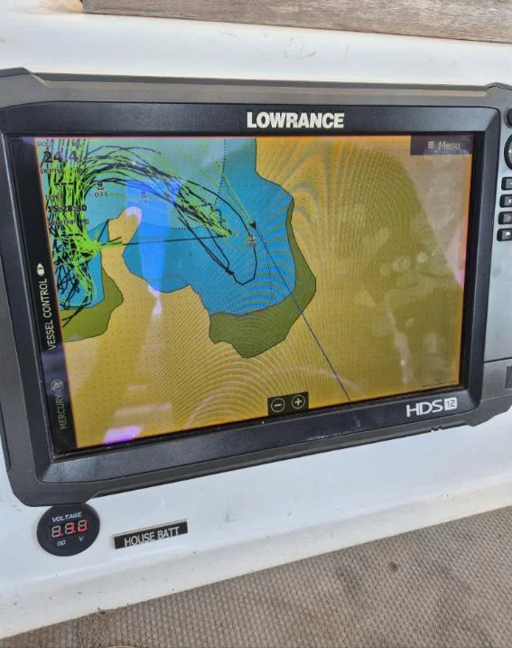 Lowrance HDS 12 chartplotter flush-mounted with house battery voltmeter