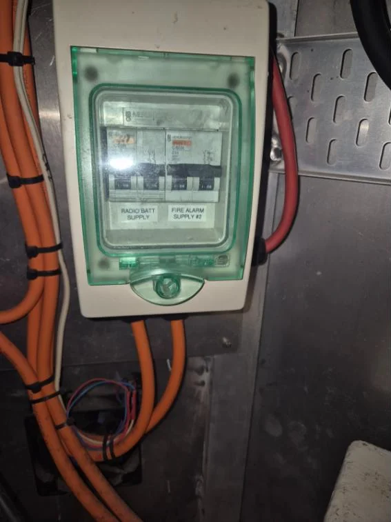 Marine AC sub-board with labelled breakers for radio battery and fire alarm supplies