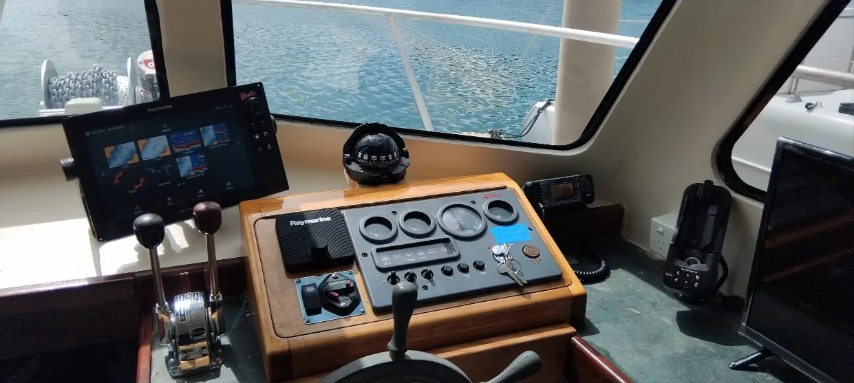 Raymarine Axiom chartplotter, autopilot controller and VHF radio at the helm of the training vessel Beagle II