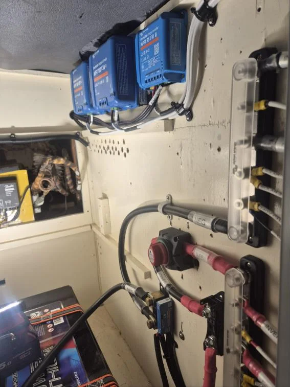 Three Victron SmartSolar MPPT controllers with busbars and battery isolator on a yacht