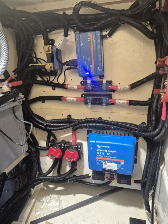 Victron Cerbo GX, battery shunt, labelled MEGA fuses, Orion-Tr Smart charger and battery switches on a yacht